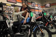 Harley Davidson salesman helping motorcycle customer